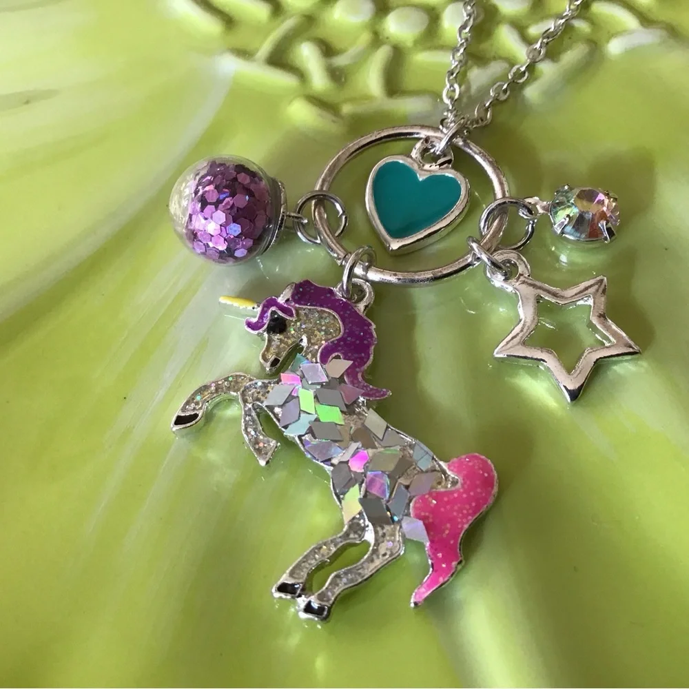 NWT Justice necklace. Unicorn, heart, glitter ball, star and rhinestone charms.